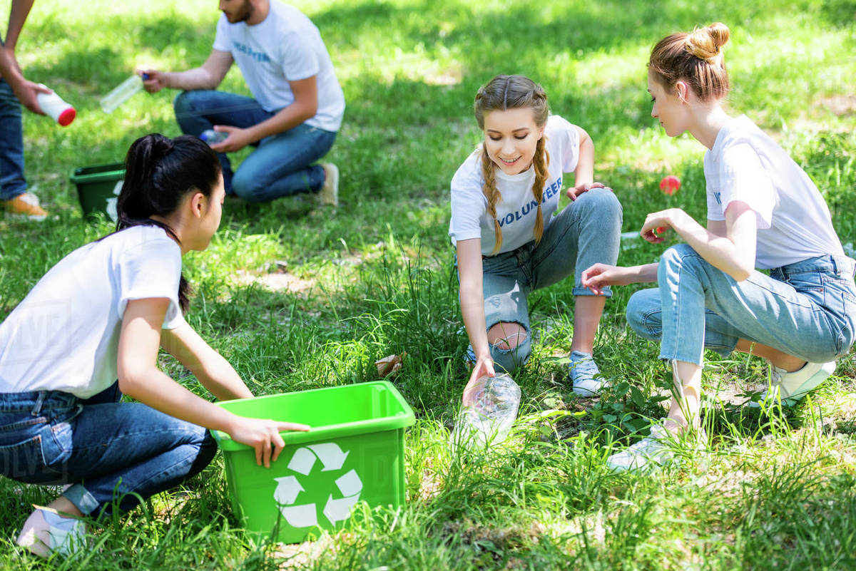 A group of young people are collecting trash for recycling.