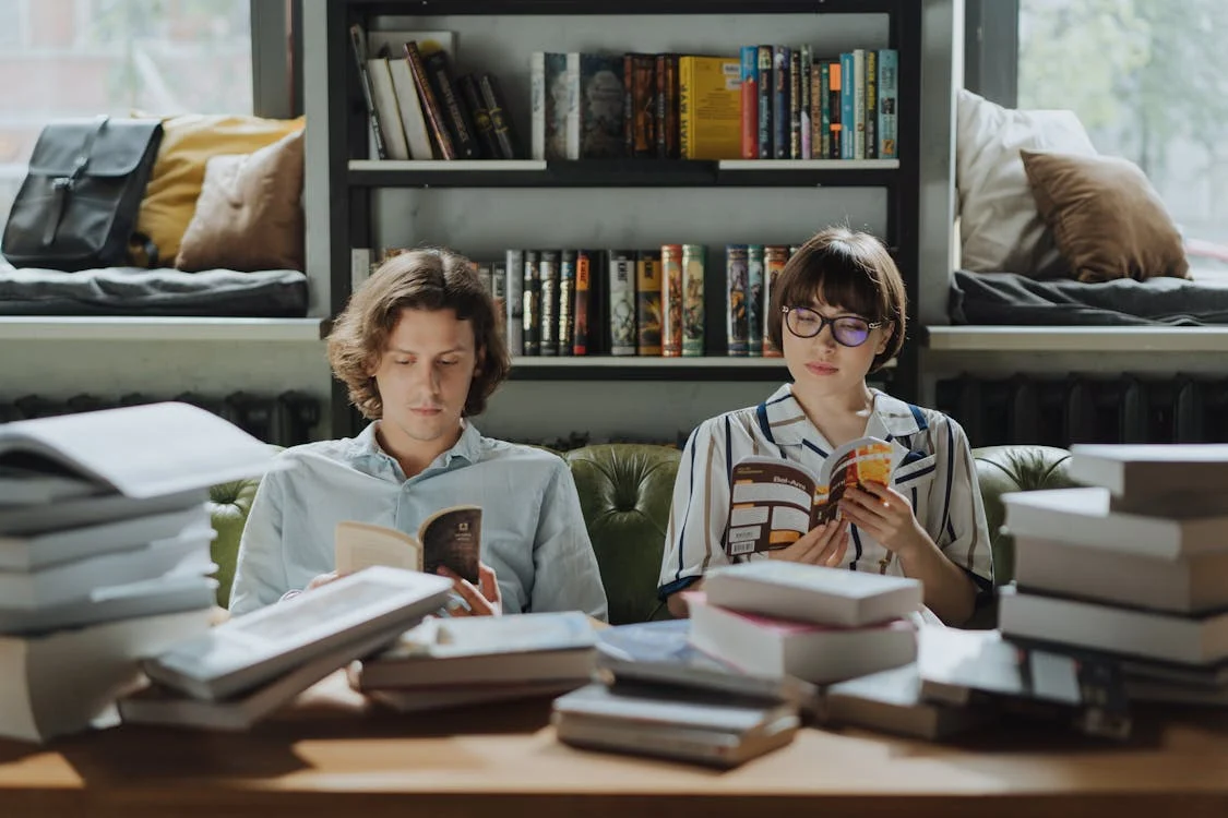 Man and Woman Reading Books